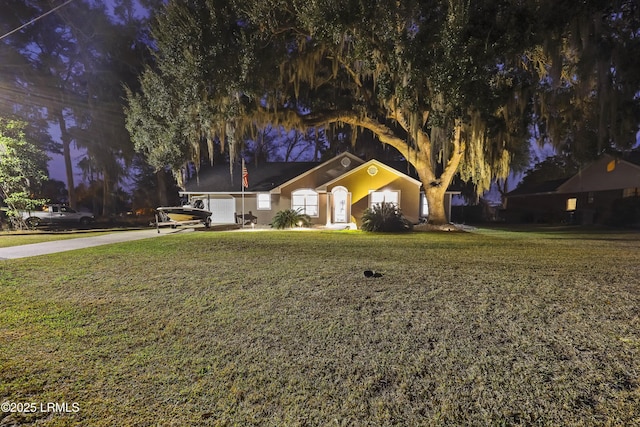 view of front of property featuring a garage and a front lawn