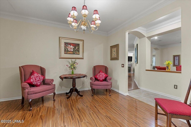 10 Screven Ct, Bluffton, SC 29909 - living area featuring arched walkways, wood finished floors, a chandelier, ornamental molding, and baseboards