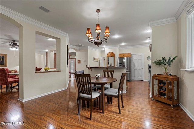 10 Screven Ct, Bluffton, SC 29909 - dining room featuring arched walkways, wood finished floors, baseboards, and ornamental molding