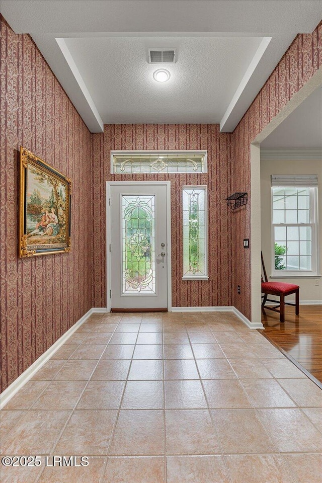 10 Screven Ct, Bluffton, SC 29909 - entrance foyer featuring a textured ceiling, wallpapered walls, healthy amount of natural light, baseboards, and light tile patterned flooring