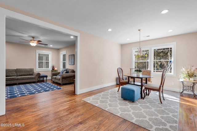 dining area with ceiling fan and wood-type flooring