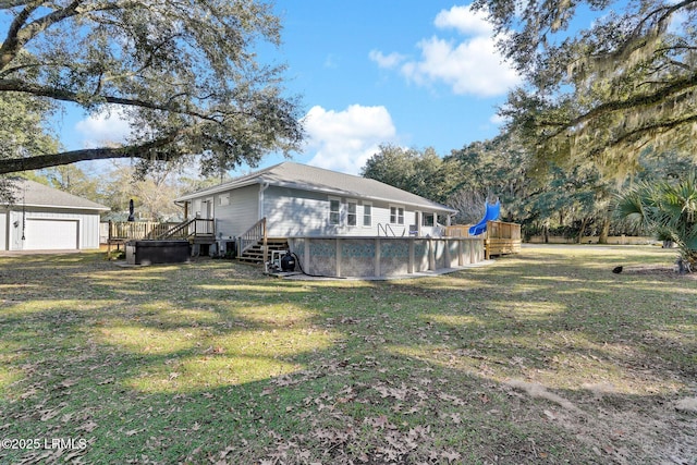 view of property exterior featuring a swimming pool side deck, a lawn, and a garage