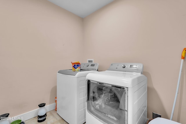 clothes washing area featuring independent washer and dryer