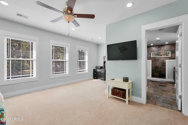 living room featuring light carpet and ceiling fan