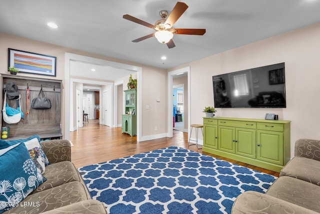 living room with hardwood / wood-style floors and ceiling fan