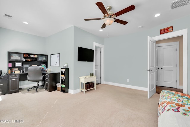 home office featuring light carpet and ceiling fan