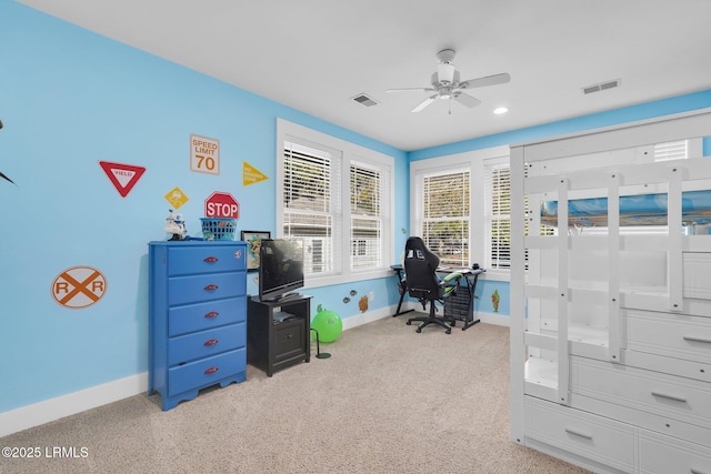 carpeted office space featuring ceiling fan