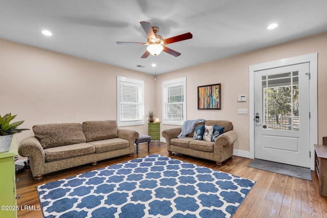 living room featuring a healthy amount of sunlight, hardwood / wood-style floors, and ceiling fan