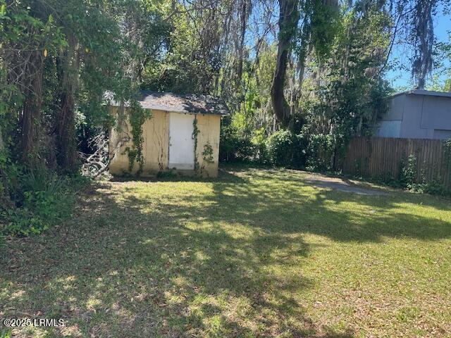 1006 Duke St, Beaufort, SC 29902 - view of yard with fence, a storage unit, and an outbuilding