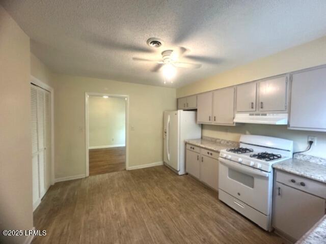 1006 Duke St, Beaufort, SC 29902 - kitchen with wood finished floors, white appliances, ceiling fan, light countertops, and under cabinet range hood