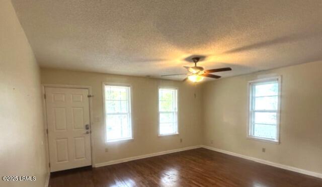 1006 Duke St, Beaufort, SC 29902 - entryway with dark wood-style flooring, a textured ceiling, ceiling fan, and baseboards