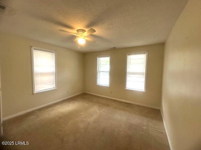 1006 Duke St, Beaufort, SC 29902 - carpeted empty room featuring a ceiling fan, baseboards, and a textured ceiling