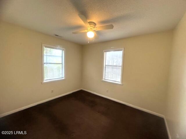 1006 Duke St, Beaufort, SC 29902 - unfurnished room featuring a ceiling fan, baseboards, and dark colored carpet