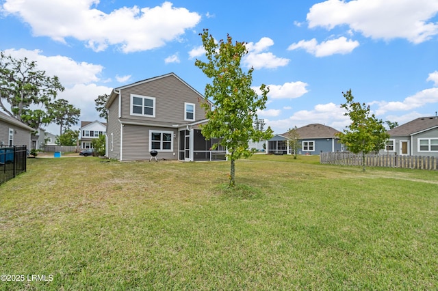 23 Toxaway Ln, Beaufort, SC 29906 - back of house featuring fence, a sunroom, and a yard