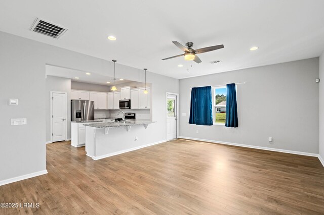 23 Toxaway Ln, Beaufort, SC 29906 - kitchen with visible vents, a ceiling fan, a peninsula, appliances with stainless steel finishes, and a breakfast bar area