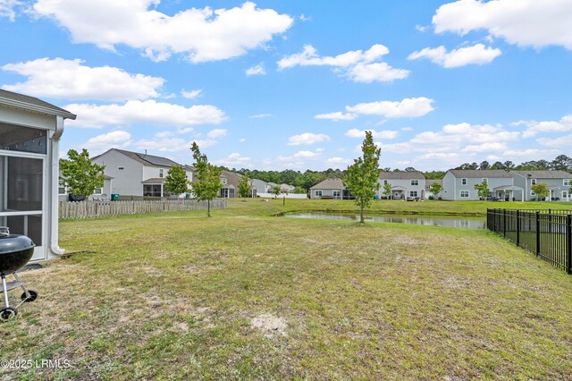23 Toxaway Ln, Beaufort, SC 29906 - view of yard with a residential view, a sunroom, a water view, and fence