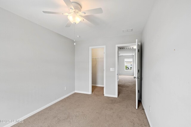 23 Toxaway Ln, Beaufort, SC 29906 - unfurnished bedroom with a closet, a walk in closet, light colored carpet, baseboards, and visible vents