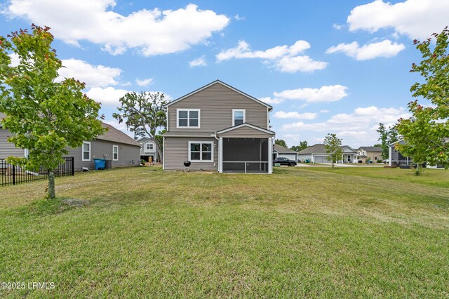 23 Toxaway Ln, Beaufort, SC 29906 - rear view of house featuring a sunroom, fence, and a lawn