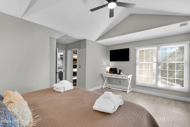 bedroom with washer / dryer, vaulted ceiling, and ceiling fan