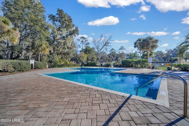 view of swimming pool with a patio area