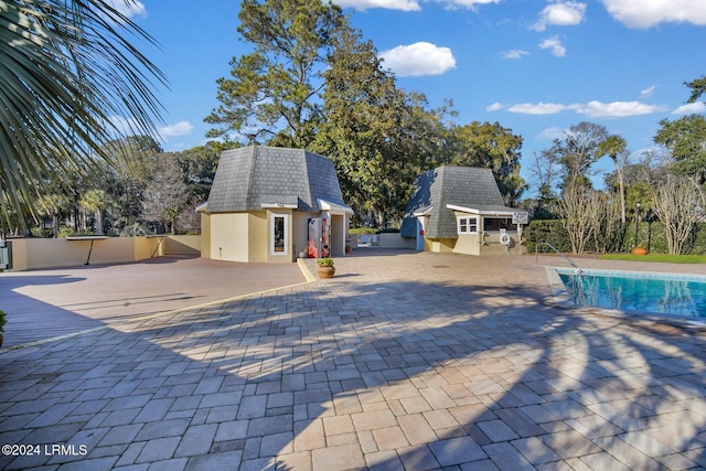 view of pool with an outdoor structure and a patio area