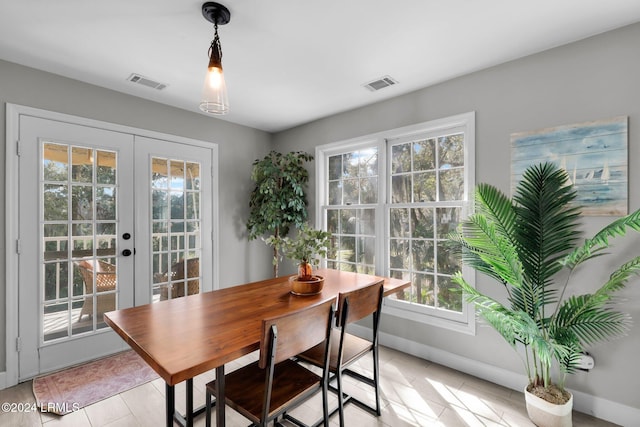 dining space featuring light tile patterned floors and french doors