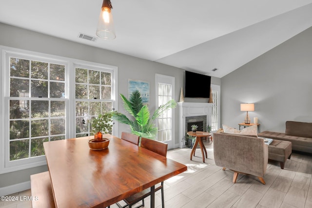 dining room featuring lofted ceiling