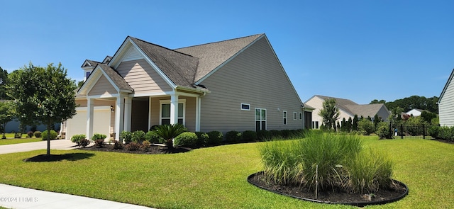 view of home's exterior with a yard and a garage