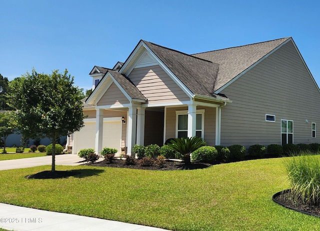 view of side of home with an attached garage, a shingled roof, a lawn, and concrete driveway