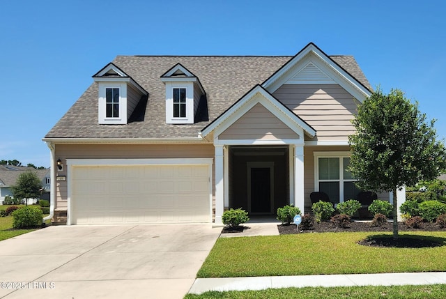 view of front of home with a garage, driveway, a front lawn, and roof with shingles