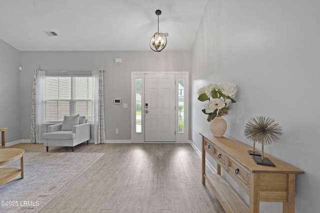 64 Grovewood Dr, Bluffton, SC 29910 - foyer featuring wood finished floors, a chandelier, and baseboards