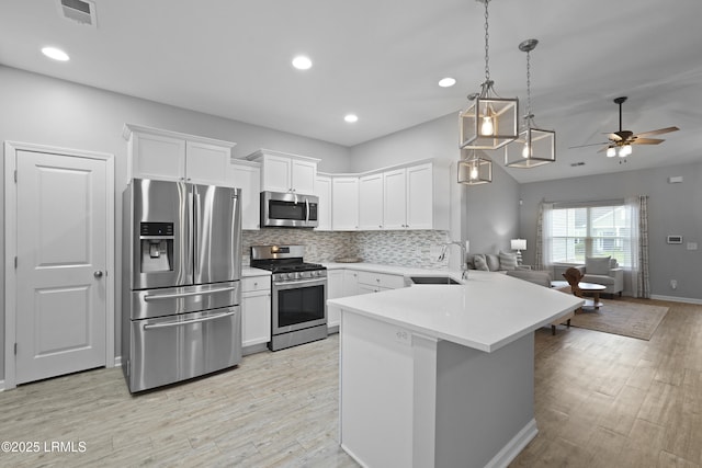 64 Grovewood Dr, Bluffton, SC 29910 - kitchen with appliances with stainless steel finishes, a peninsula, a ceiling fan, open floor plan, and a sink
