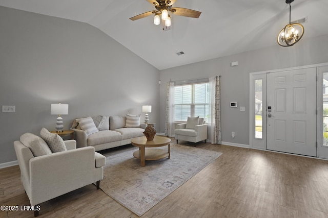 64 Grovewood Dr, Bluffton, SC 29910 - living room featuring lofted ceiling, a chandelier, wood finished floors, ceiling fan, and baseboards