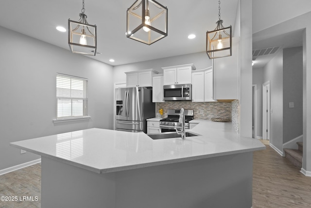 64 Grovewood Dr, Bluffton, SC 29910 - kitchen with appliances with stainless steel finishes, a sink, baseboards, light countertops, and decorative backsplash