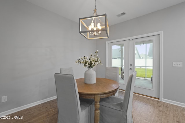 64 Grovewood Dr, Bluffton, SC 29910 - dining room with a chandelier, french doors, wood finished floors, and baseboards