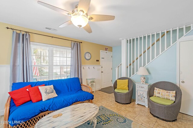 living room featuring ceiling fan and light tile patterned floors