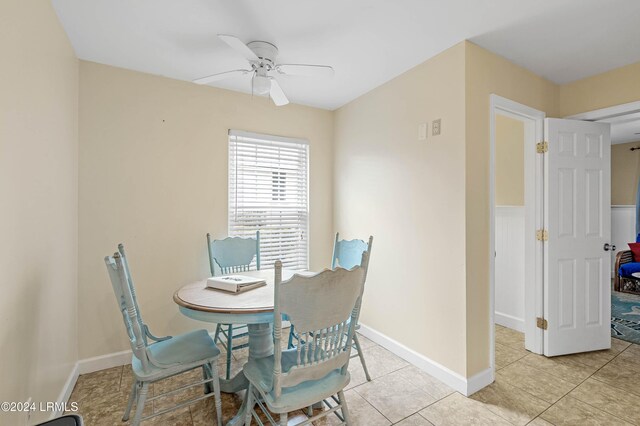 tiled dining space with ceiling fan