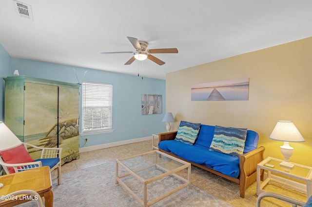 tiled living room with ceiling fan