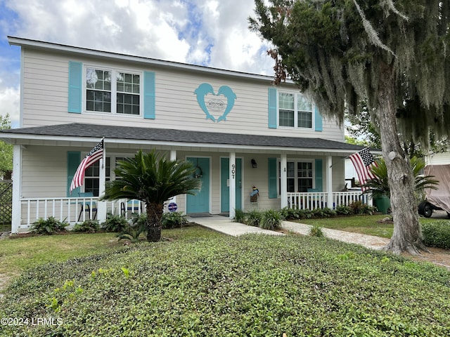 view of front of home with a porch and a front lawn