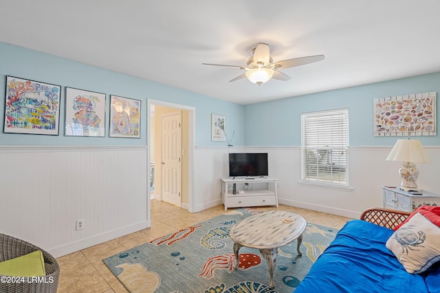 tiled living room with ceiling fan