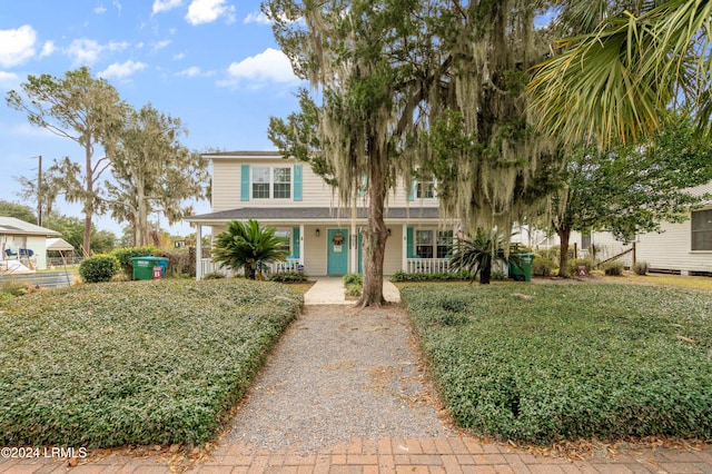 view of front of home featuring a front yard and a porch