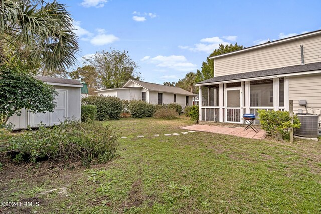 view of yard with a shed, central AC, a patio area, and a sunroom