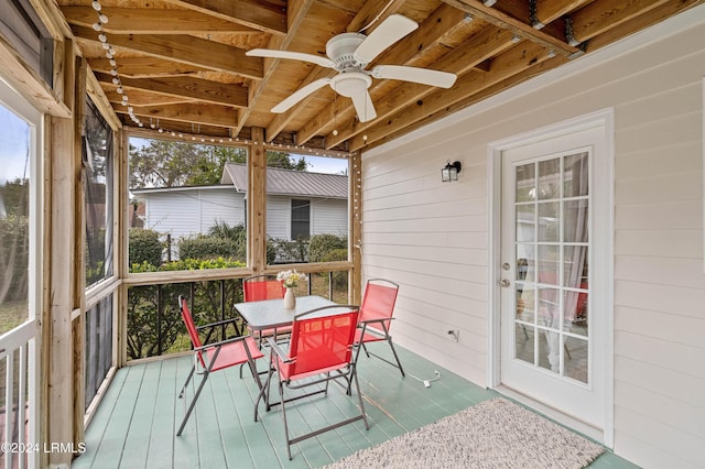 sunroom featuring ceiling fan