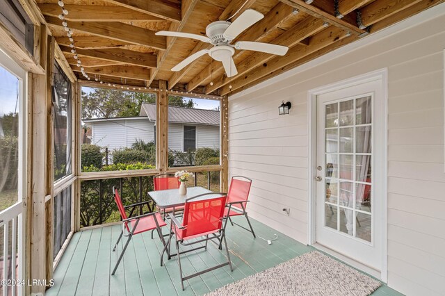 sunroom featuring ceiling fan