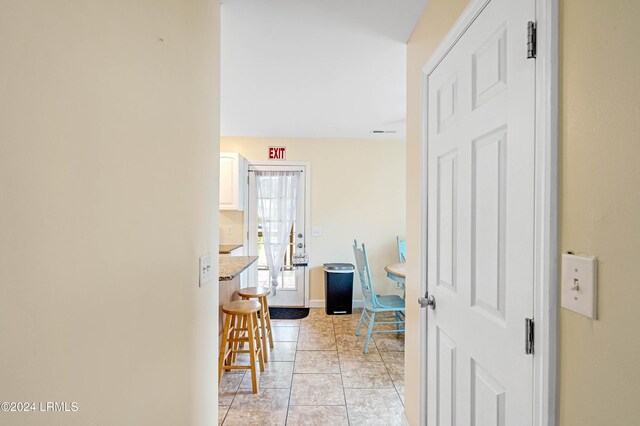 hall with light tile patterned flooring