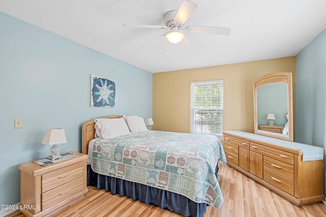 bedroom with ceiling fan and light hardwood / wood-style floors