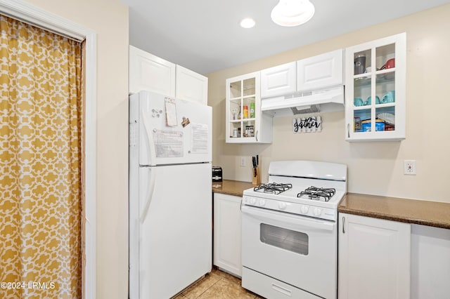 kitchen with white cabinetry, white appliances, and light tile patterned flooring