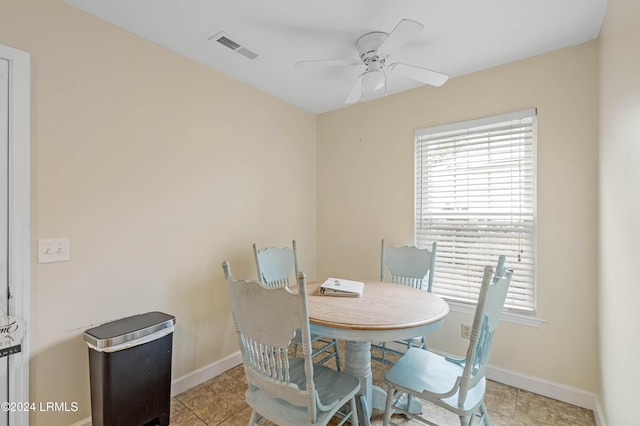 dining area with light tile patterned flooring and ceiling fan