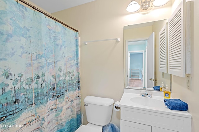 bathroom with vanity, a shower with shower curtain, and toilet