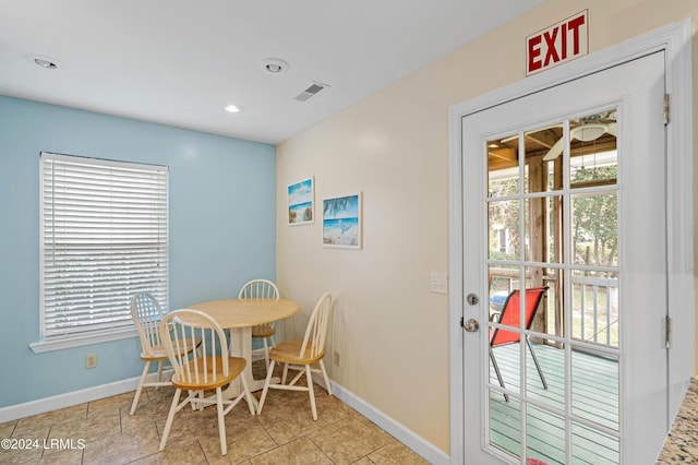 dining area featuring plenty of natural light and light tile patterned flooring